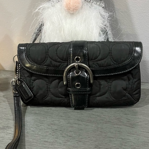 Elegant Coach Black Quilted Women\'s Clutch/Wristlet with gunmetal hardware.